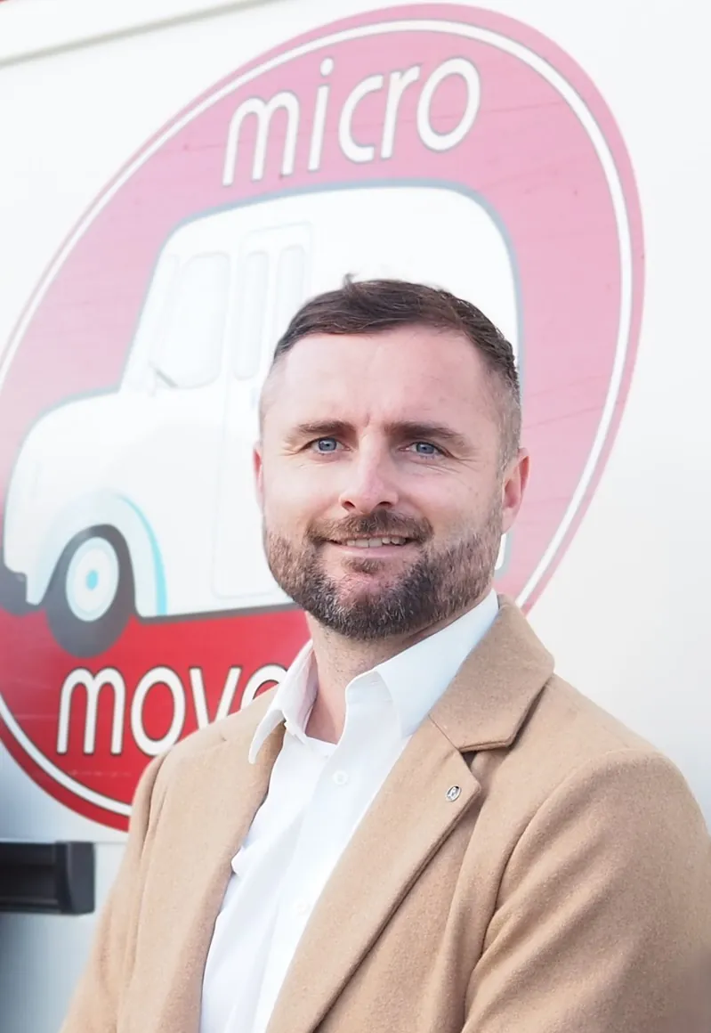 Austin Gaskin beside the Micro Moves van