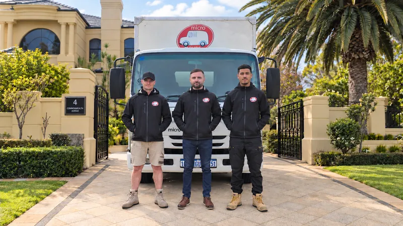 Micro Moves team standing in front of their moving truck